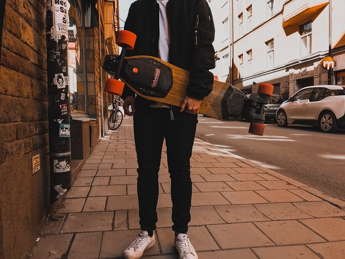 man showing his electric skateboard